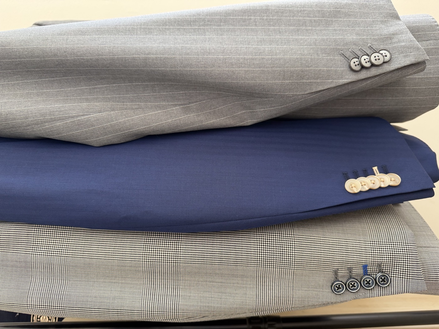 Working surgeon's-cuff buttonholes on three bespoke jackets
