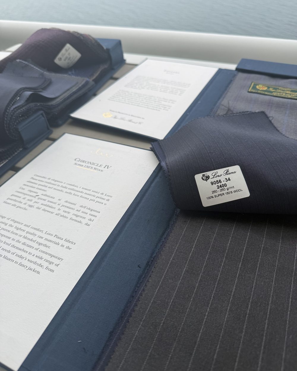 Loro Piana Chronicle Super 150's wool swatch book over the ocean
