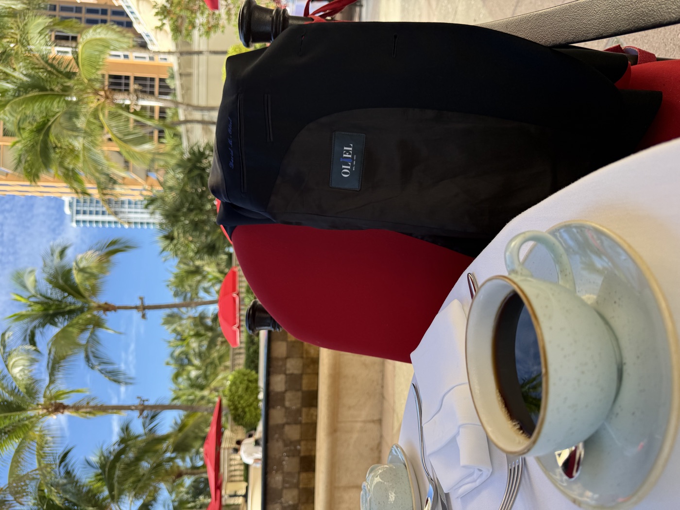 Black Oliel jacket over a chair at an oceanfront resort