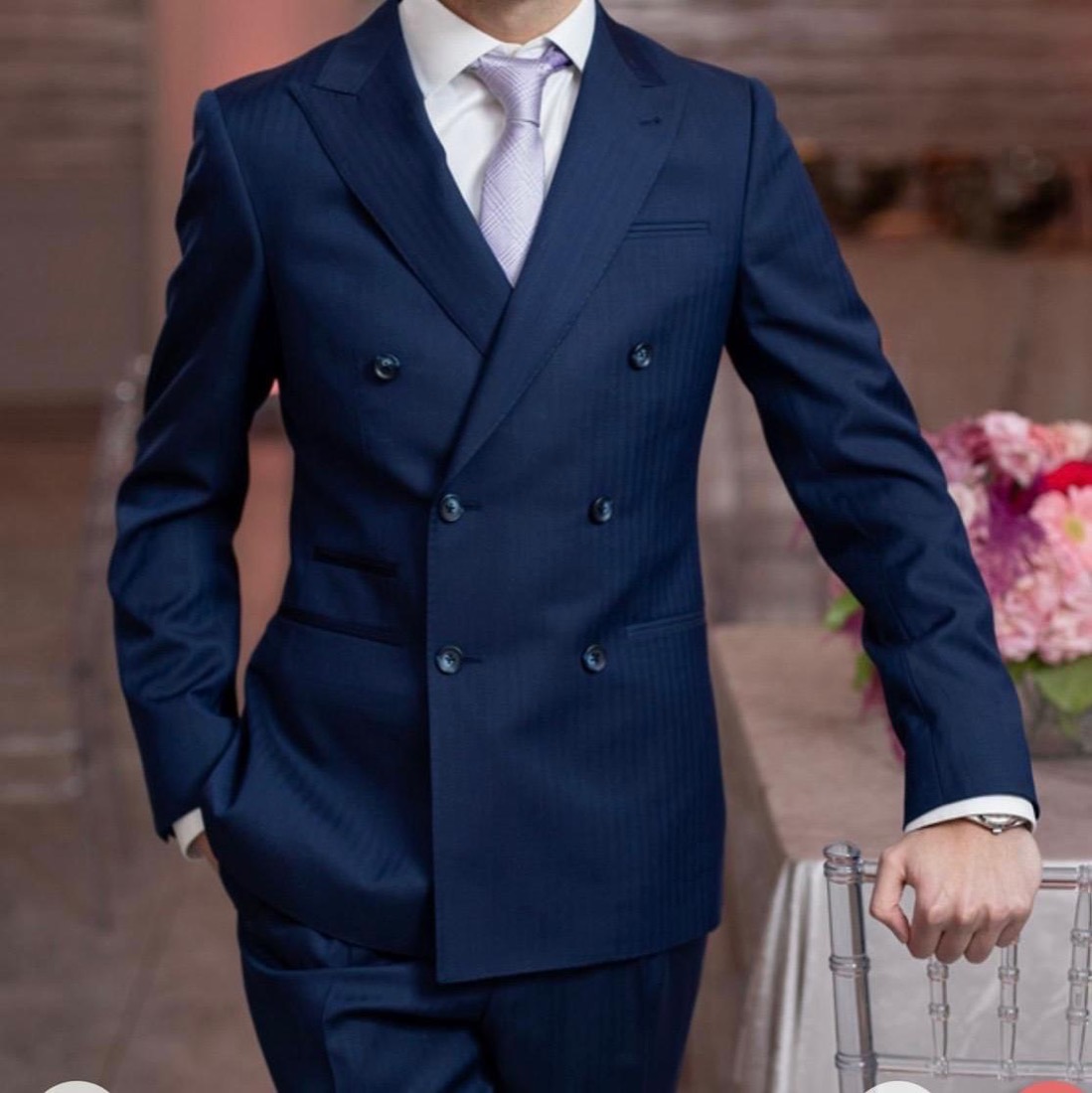 Client in a navy double-breasted Oliel suit at an event