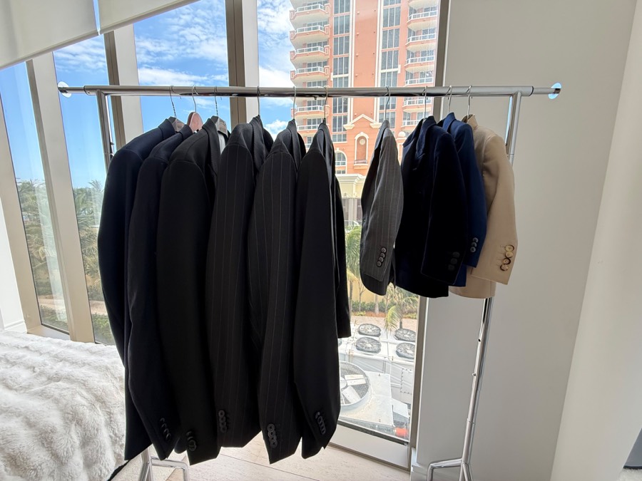 Rack of Oliel suits by the window