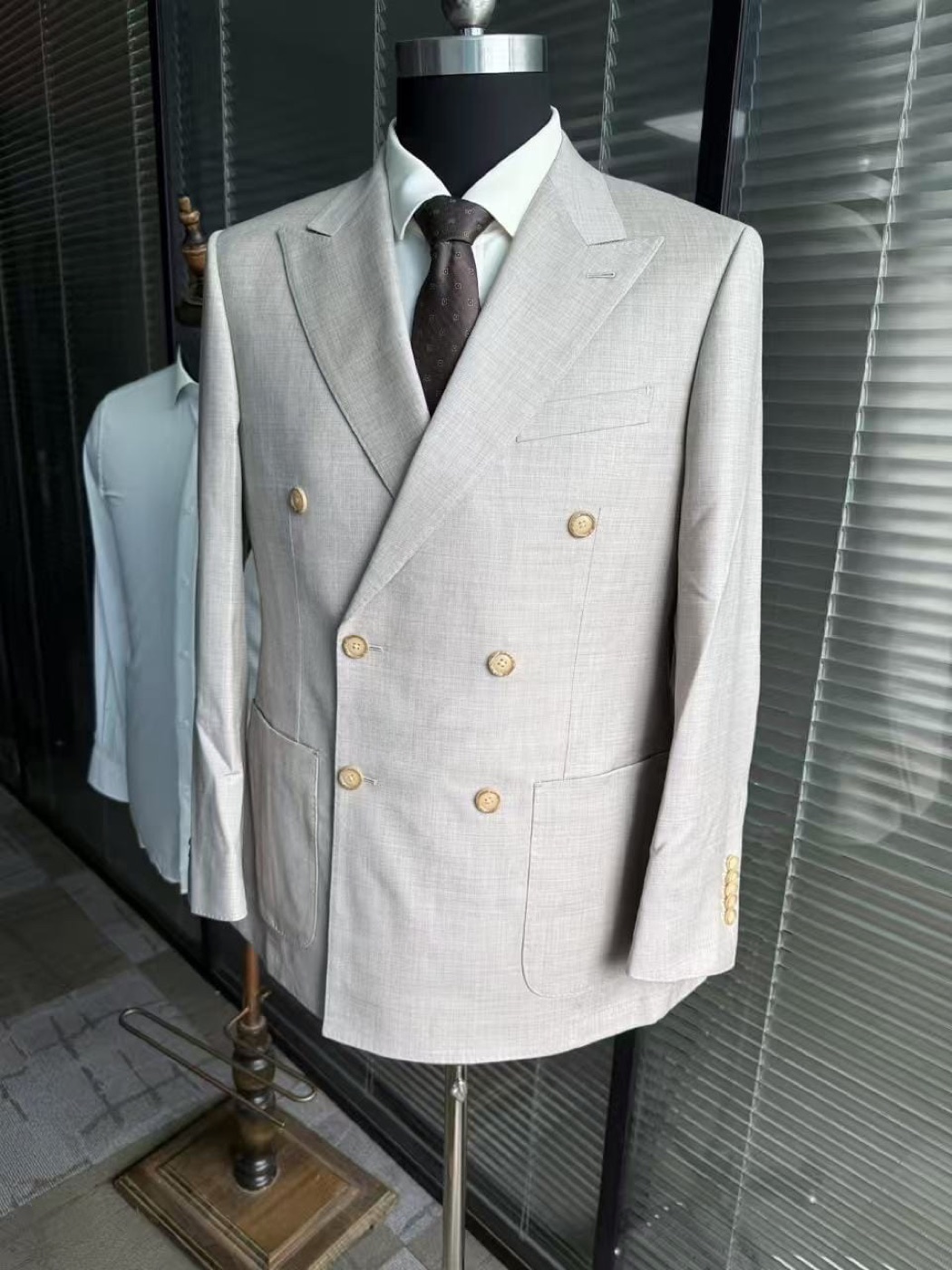 Cream double-breasted suit with tan buttons